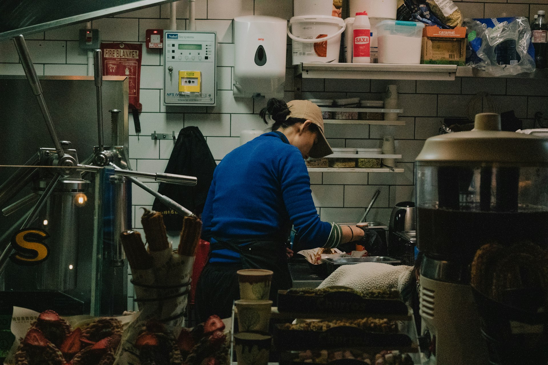 Cooks working the line in a busy restaurant kitchen during dinner service